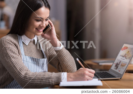Glad smiling woman talking on cellphone and making Glad smiling woman talking on cellphone and making 26086004