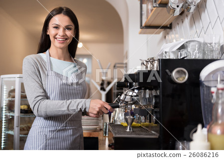 Happy pretty woman using coffee machine. Happy pretty woman using coffee machine. 26086216