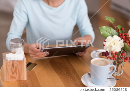 Attractive young woman using her digital device 26086828