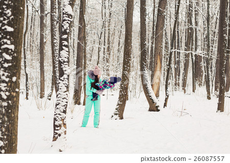 Mother and little toddler girl walking in the 26087557