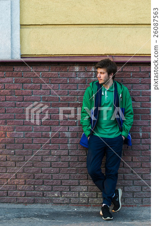 Common young man wearing green t-shirt jacket and Common young man wearing green t-shirt jacket and 26087563