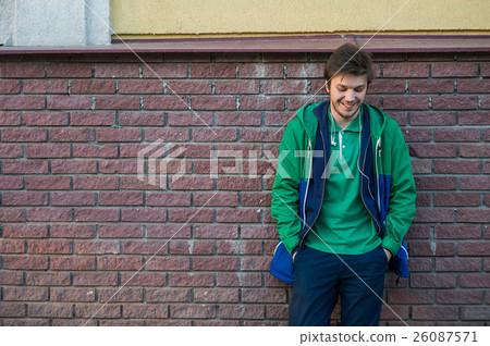 Common young man wearing green t-shirt jacket and Common young man wearing green t-shirt jacket and 26087571