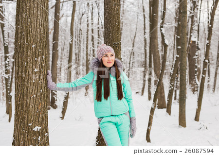 Beautiful young girl in a white winter forest Beautiful young girl in a white winter forest 26087594