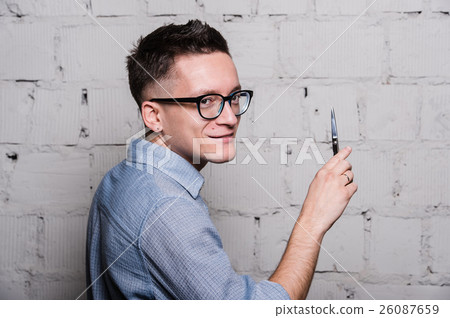 Young male hairdresser in glasses, posing with 26087659