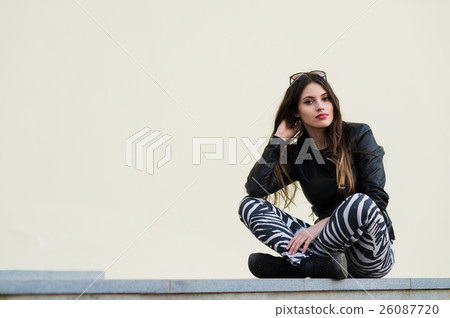 Confident attractive young female student sitting Confident attractive young female student sitting 26087720