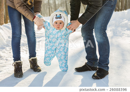 First steps. Little baby learning to walk. Mother 26088396