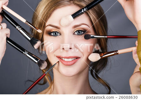 Many hands doing make up to glamour woman. 26088630