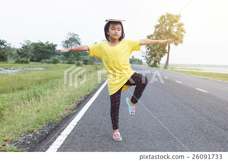 The cute girl was playing standing arms and legs one side. with The cute girl was playing standing arms and legs one side. with 26091733