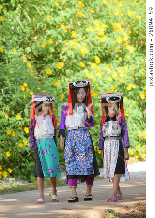 Three Asian Lahu girl in custom dress walking . 26094159