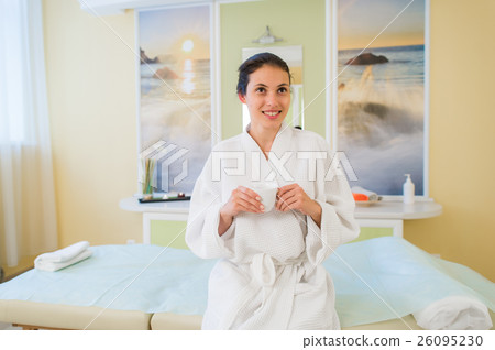 Pretty young Hispanic woman wearing a robe and 26095230