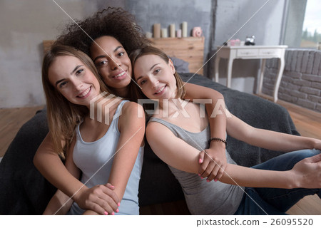 Smiling friends hugging in the bedroom at home Smiling friends hugging in the bedroom at home 26095520