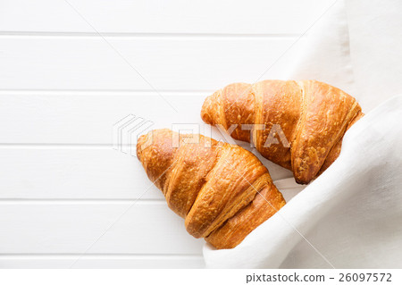 Tasty buttery croissants in napkin. 26097572