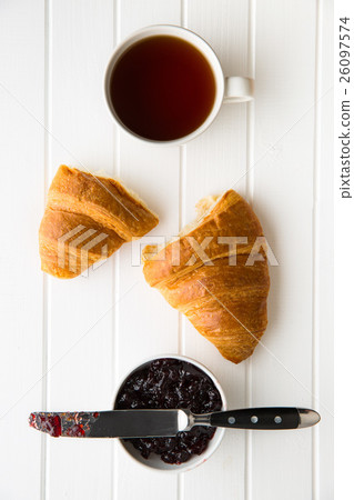 Tasty buttery croissant and jam in jar. Tasty buttery croissant and jam in jar. 26097574