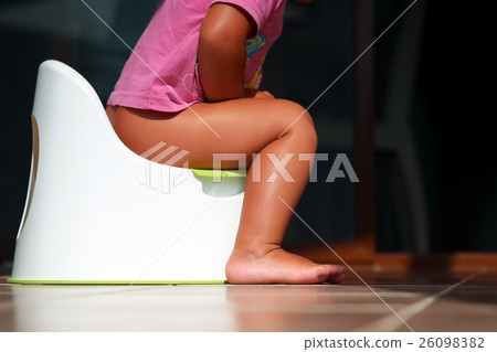 Children's legs hanging down from a chamber-pot 26098382