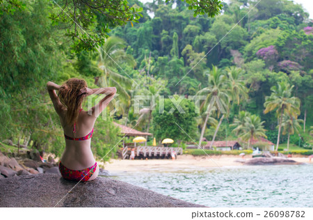 girl sitting on a stone 26098782