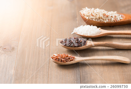 Riceberry brown rice Jasmine rice on wood spoon Riceberry brown rice Jasmine rice on wood spoon 26099730