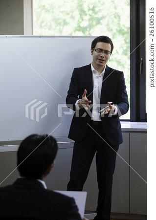 Business person who talks while watching personal computer Business person who talks while watching personal computer 26100516