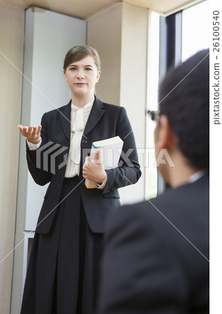 Businesswoman standing with a book 26100540