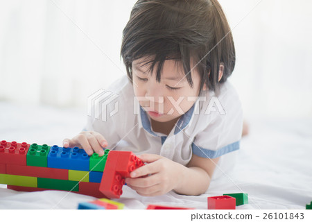 asian child playing colorful construction blocks 26101843