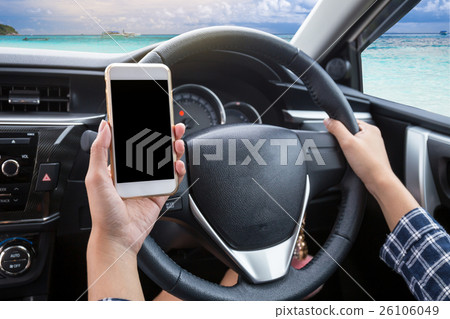 Young female driver using touch screen smartphone 26106049