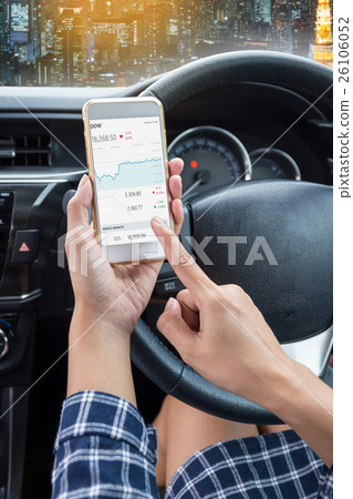 Young female driver using touch screen smartphone 26106052