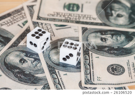Two dices on wood table with US dollar 26106520