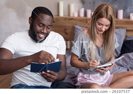 Happy couple making notes together 26107537