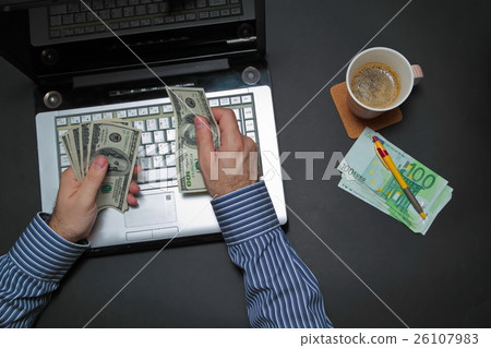 Businessman working on laptop and counting money w Businessman working on laptop and counting money w 26107983