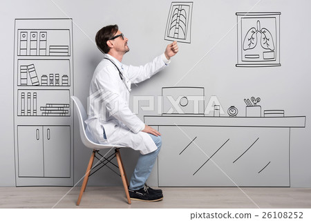Positive doctor sitting on the chair Positive doctor sitting on the chair 26108252