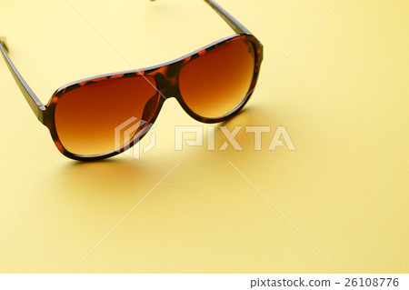 Sunglasses in empty yellow background 26108776