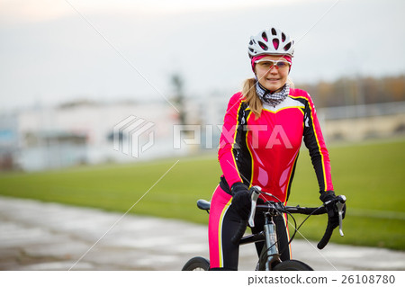 Young smiling athletic female cyclist in special 26108780
