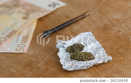 close up on Marijuana in tin foil with pipe, close up on Marijuana in tin foil with pipe, 26110430