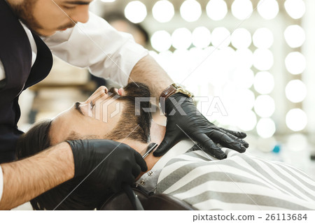 Hands in gloves making beard form 26113684