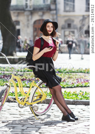 Young girl on bicycle with phone Young girl on bicycle with phone 26114912