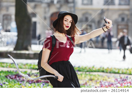 Beautiful girl on bicycle making selfie Beautiful girl on bicycle making selfie 26114914