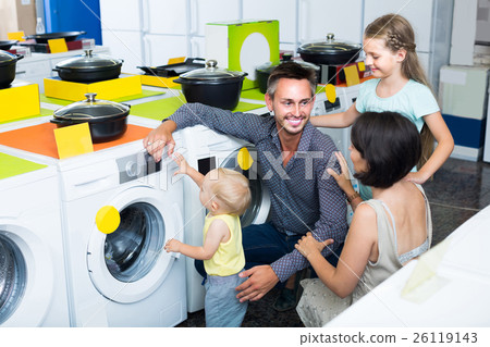 parents with two kids choosing washing machine in home appliance store 26119143