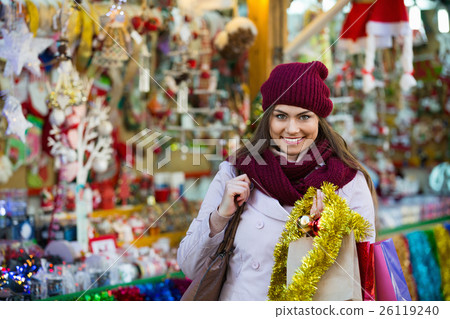 Beautiful cheerful smiling woman choosing Christmas decoration 26119240