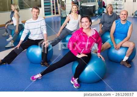 people stretching on fitness balls people stretching on fitness balls 26120037