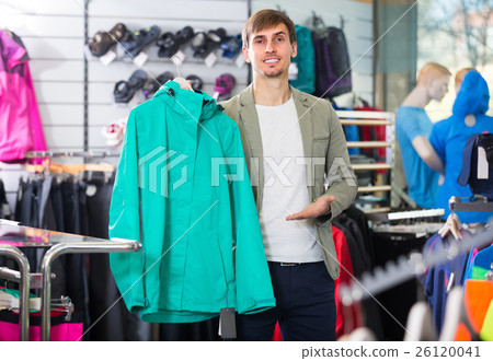Man picking a cardigan in the sport shop Man picking a cardigan in the sport shop 26120041