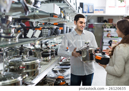 couple chooses pans in shop cookware 26120635