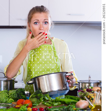 Worried housewife with spoiled food. Worried housewife with spoiled food. 26120931