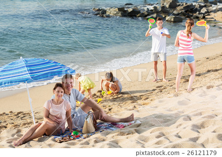 Big family resting on beach 26121179