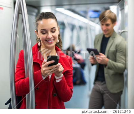 subway passengers with phones subway passengers with phones 26121246