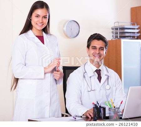 Two doctors in private clinic . 26121410