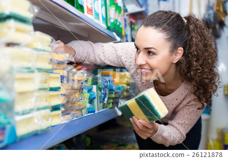 Housewife buying cleaning sponge. 26121878