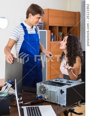 Girl and repairman fixing computer . Girl and repairman fixing computer . 26121902