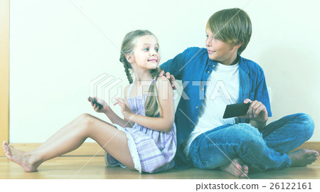 girl and boy burying in mobile phones 26122161