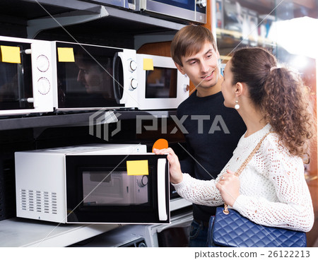 couple buying microwave oven in hypermarket and smiling 26122213