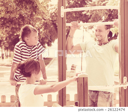 parents with child training with pull-up bar parents with child training with pull-up bar 26122474