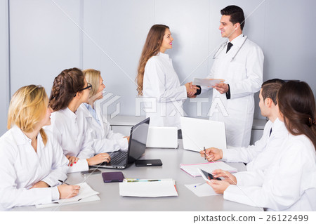 Interns and professor cooperating 26122499